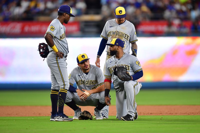 Aug 15, 2023; Los Angeles, California, USA; Milwaukee Brewers third baseman Andruw Monasterio (14) shortstop Willy Adames (27) first baseman Carlos Santana (41) and second baseman Brice Turang (2) meet during a pitching change during the sixth inning at Dodger Stadium. Mandatory Credit: Gary A. Vasquez-USA TODAY Sports