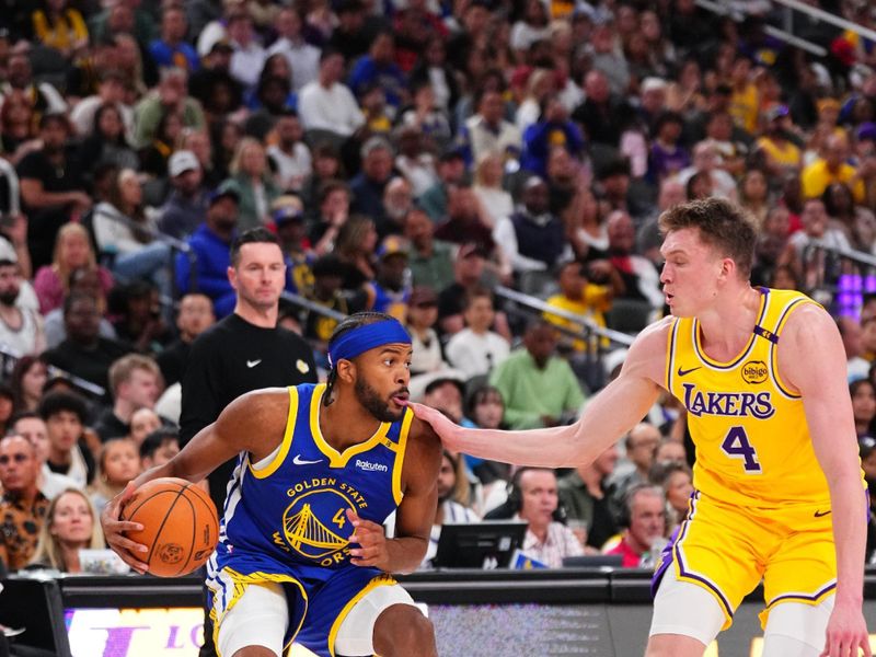 LAS VEGAS, NV - OCTOBER 15: Moses Moody #4 of the Golden State Warriors dribbles the ball during the game against the Los Angeles Lakers during the 2024 NBA Preseason on October 15, 2024 at T-Mobile Arena in Las Vegas, Nevada. NOTE TO USER: User expressly acknowledges and agrees that, by downloading and or using this photograph, User is consenting to the terms and conditions of the Getty Images License Agreement. Mandatory Copyright Notice: Copyright 2024 NBAE  (Photo by Jeff Bottari/NBAE via Getty Images)