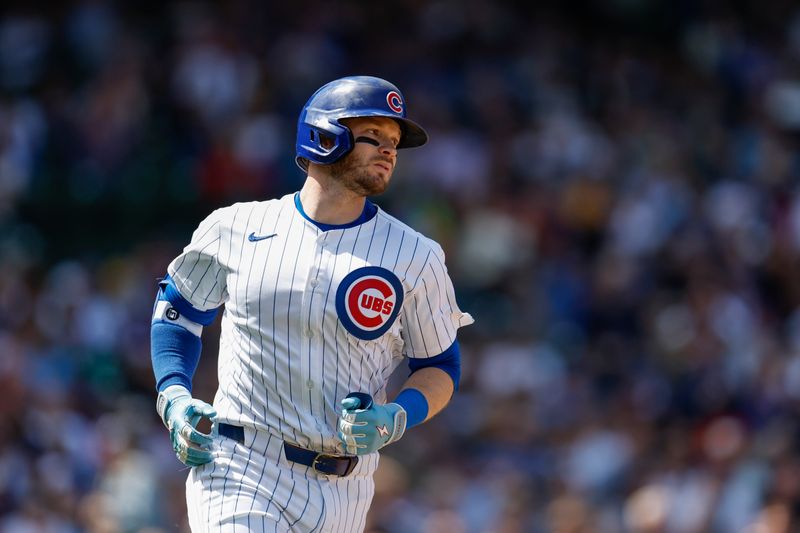 May 3, 2024; Chicago, Illinois, USA; Chicago Cubs outfielder Ian Happ (8) runs to first base after hitting a single against the Milwaukee Brewers during the fourth inning at Wrigley Field. Mandatory Credit: Kamil Krzaczynski-USA TODAY Sports