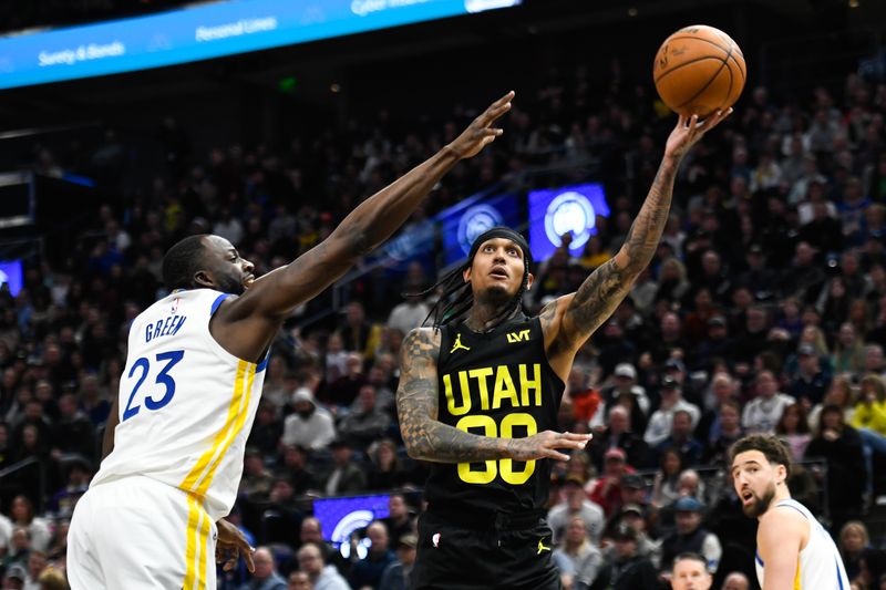 SALT LAKE CITY, UTAH - FEBRUARY 12: Jordan Clarkson #00 of the Utah Jazz puts up a shot against Draymond Green #23 of the Golden State Warriors during the second half at Delta Center on February 12, 2024 in Salt Lake City, Utah. NOTE TO USER: User expressly acknowledges and agrees that, by downloading and or using this photograph, User is consenting to the terms and conditions of the Getty Images License Agreement.  (Photo by Alex Goodlett/Getty Images)