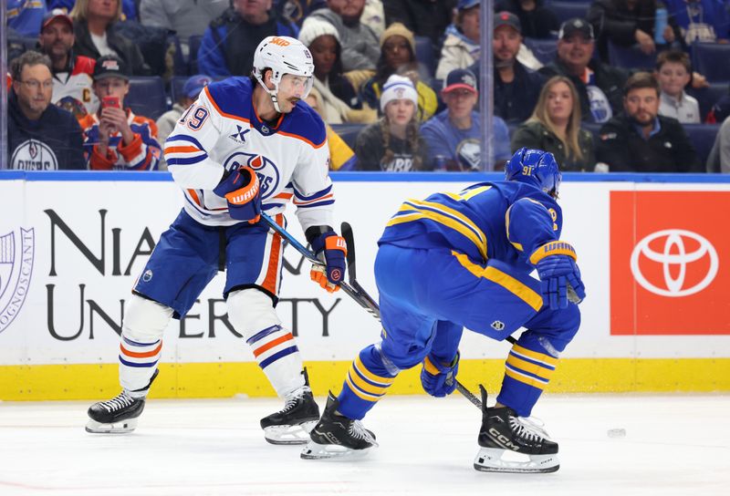Nov 17, 2025; Buffalo, New York, USA;  aBuffalo Sabres right wing Josh Doan (91) tries to block a pass by Edmonton Oilers center Adam Henrique (19) during the first period at KeyBank Center. Mandatory Credit: Timothy T. Ludwig-Imagn Images