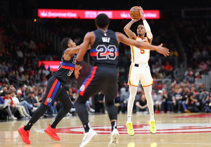 ATLANTA, GEORGIA - APRIL 03:  Dejounte Murray #5 of the Atlanta Hawks attempts a three-point basket against Marcus Sasser #25 of the Detroit Pistons during the second quarter at State Farm Arena on April 03, 2024 in Atlanta, Georgia.  NOTE TO USER: User expressly acknowledges and agrees that, by downloading and/or using this photograph, user is consenting to the terms and conditions of the Getty Images License Agreement.  (Photo by Kevin C. Cox/Getty Images)