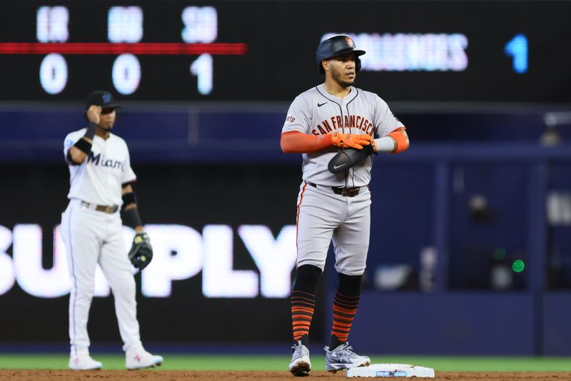 Apr 17, 2024; Miami, Florida, USA; San Francisco Giants second baseman Thairo Estrada (39) watches from second base after hitting an RBI double against the Miami Marlins during the second inning at loanDepot Park. Mandatory Credit: Sam Navarro-USA TODAY Sports