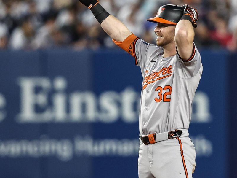 Jun 19, 2024; Bronx, New York, USA;  Baltimore Orioles designated hitter Ryan O'Hearn (32) gestures to the dugout after hitting a RBI double in the fifth inning against the New York Yankees at Yankee Stadium. Mandatory Credit: Wendell Cruz-USA TODAY Sports