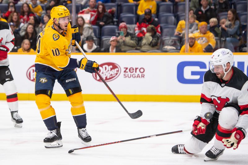 Feb 13, 2024; Nashville, Tennessee, USA;  New Jersey Devils defenseman Brendan Smith (2) blocks the shot of Nashville Predators center Colton Sissons (10) during the third period at Bridgestone Arena. Mandatory Credit: Steve Roberts-USA TODAY Sports