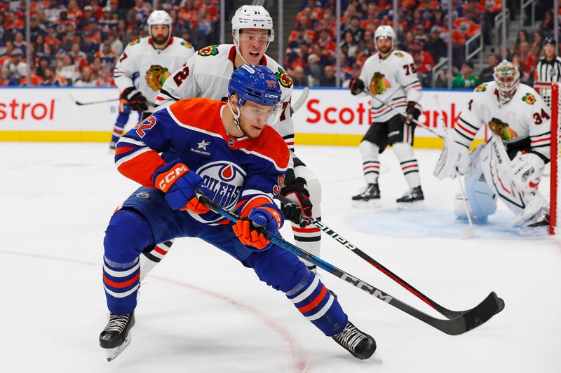 Oct 12, 2024; Edmonton, Alberta, CAN; Edmonton Oilers forward Vasily Podkolzin (92) and Chicago Blackhawks defensemen Alex Vlasic (72) chase a loose puck during the first period at Rogers Place. Mandatory Credit: Perry Nelson-Imagn Images