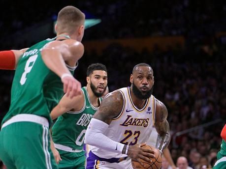 LOS ANGELES, CALIFORNIA - DECEMBER 25: LeBron James #23 of the Los Angeles Lakers is defended by Kristaps Porzingis #8 of the Boston Celtics at Crypto.com Arena on December 25, 2023 in Los Angeles, California. NOTE TO USER: User expressly acknowledges and agrees that, by downloading and or using this photograph, User is consenting to the terms and conditions of the Getty Images License Agreement.(Photo by Jayne Kamin-Oncea/Getty Images)