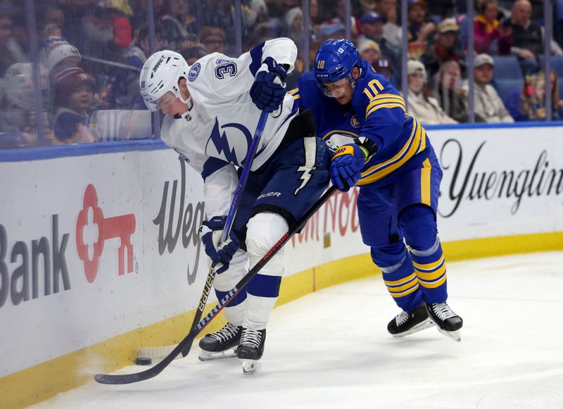 Jan 20, 2024; Buffalo, New York, USA;   Tampa Bay Lightning Waltteri Merela (39) and Buffalo Sabres defenseman Henri Jokiharju (10) battle for a loose puck behind the net during the first period at KeyBank Center. Mandatory Credit: Timothy T. Ludwig-USA TODAY Sports