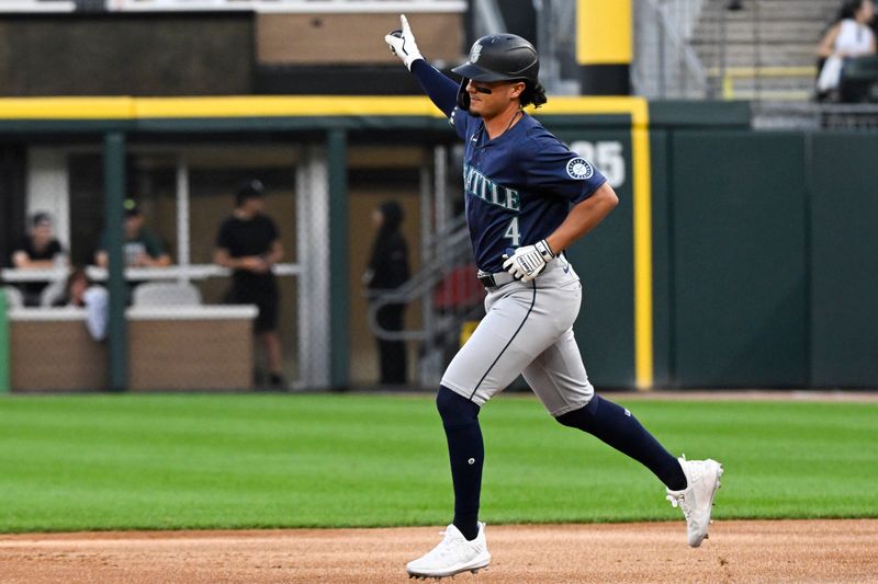 Jul 26, 2024; Chicago, Illinois, USA;  Seattle Mariners third base Josh Rojas (4) reacts after he hits a three-run home run against the Chicago White Sox during the first inning at Guaranteed Rate Field. Mandatory Credit: Matt Marton-USA TODAY Sports