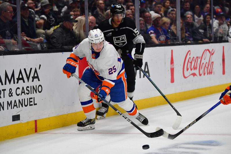 Mar 11, 2024; Los Angeles, California, USA; dNew York Islanders defenseman Sebastian Aho (25) moves the puck ahead of Los Angeles Kings right wing Quinton Byfield (55) uring the second period at Crypto.com Arena. Mandatory Credit: Gary A. Vasquez-USA TODAY Sports