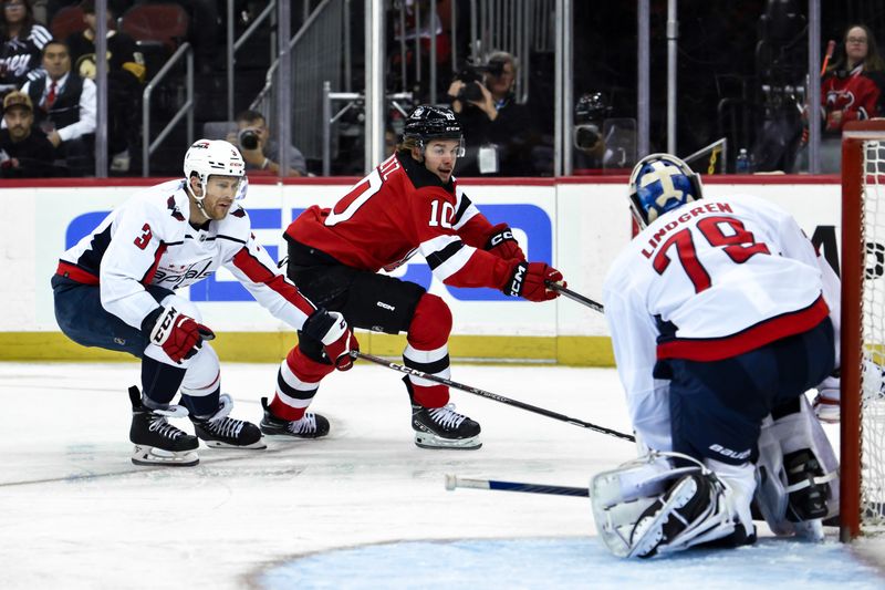 Nov 10, 2023; Newark, New Jersey, USA; New Jersey Devils right wing Alexander Holtz (10) takes a shot that is saved by Washington Capitals goaltender Charlie Lindgren (79) during the second period at Prudential Center. Mandatory Credit: John Jones-USA TODAY Sports