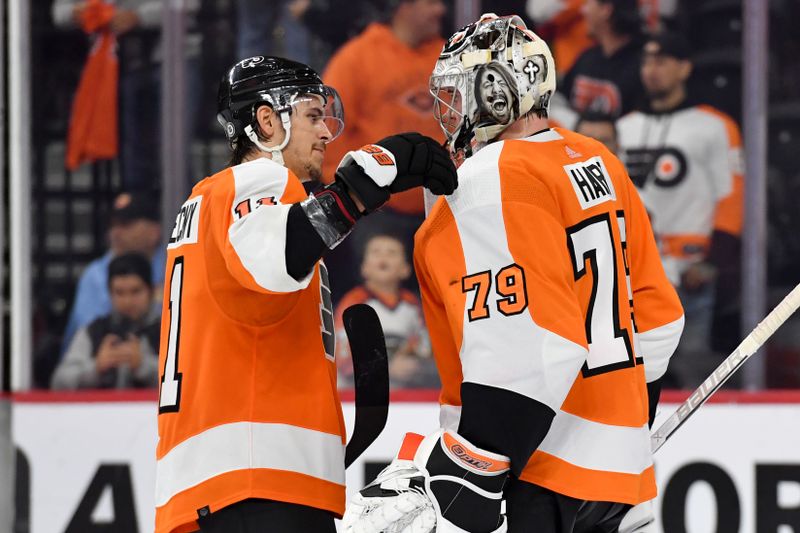 Oct 13, 2022; Philadelphia, Pennsylvania, USA; Philadelphia Flyers right wing Travis Konecny (11) and  goaltender Carter Hart (79) celebrate win against the New Jersey Devils at Wells Fargo Center. Mandatory Credit: Eric Hartline-USA TODAY Sports