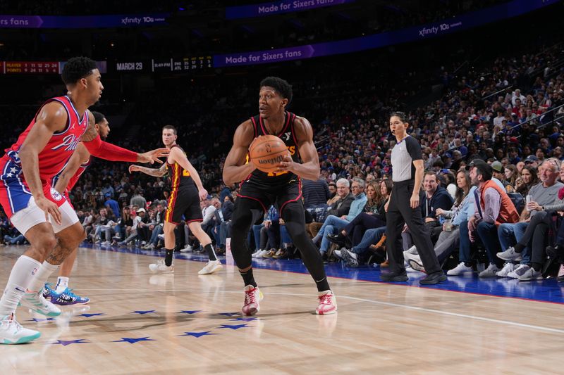 PHILADELPHIA, PA - FEBRUARY 9: De'Andre Hunter #12 of the Atlanta Hawks passes the ball during the game against the Philadelphia 76ers on February 9, 2024 at the Wells Fargo Center in Philadelphia, Pennsylvania NOTE TO USER: User expressly acknowledges and agrees that, by downloading and/or using this Photograph, user is consenting to the terms and conditions of the Getty Images License Agreement. Mandatory Copyright Notice: Copyright 2024 NBAE (Photo by Jesse D. Garrabrant/NBAE via Getty Images)