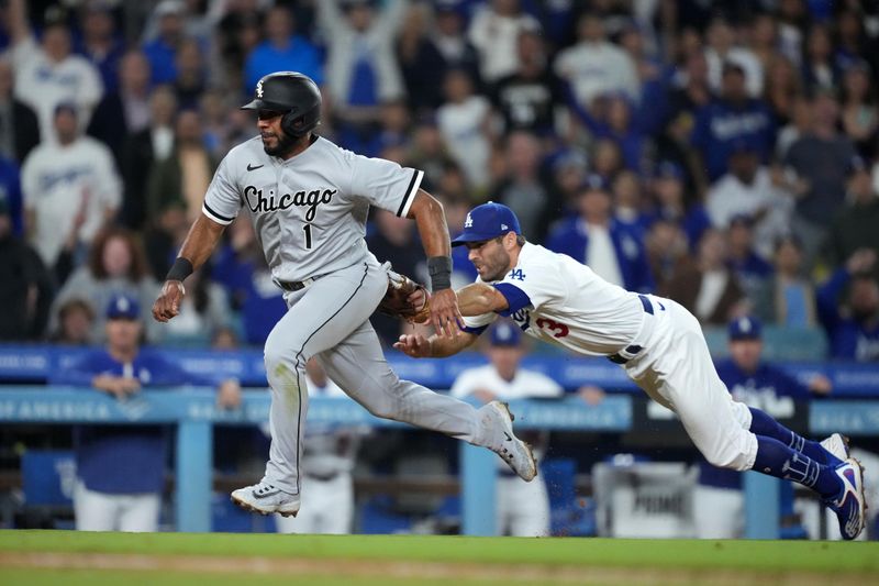 Jun 15, 2023; Los Angeles, California, USA; Chicago White Sox shortstop Elvis Andrus (1) is tagged out by Los Angeles Dodgers third baseman Chris Taylor (3) while attempting to steal home plate in the seventh inning at Dodger Stadium. Mandatory Credit: Kirby Lee-USA TODAY Sports