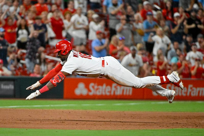 Aug 14, 2023; St. Louis, Missouri, USA;  St. Louis Cardinals right fielder Jordan Walker (18) slides head first in at third base after hitting a go-ahead three run triple against the Oakland Athletics during the seventh inning at Busch Stadium. Mandatory Credit: Jeff Curry-USA TODAY Sports