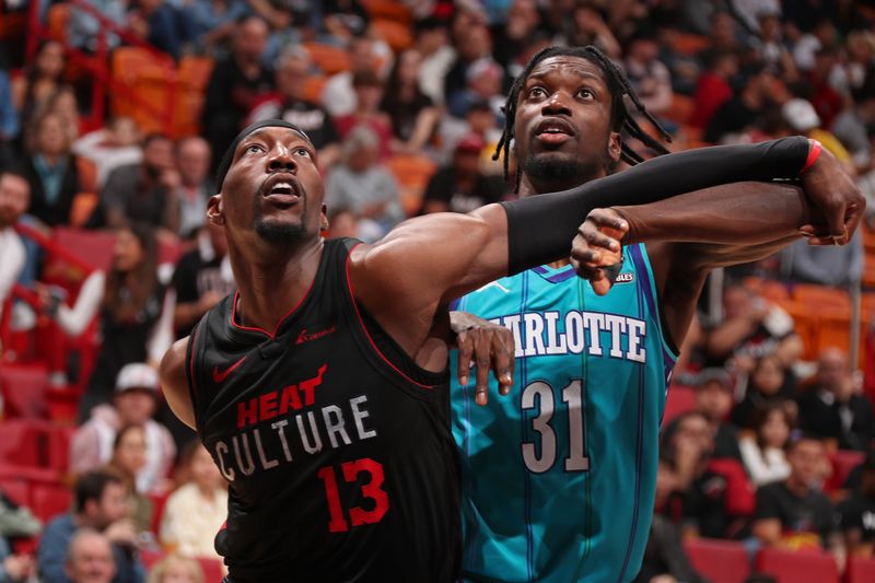 MIAMI, FL - JANUARY 14: Bam Adebayo #13 of the Miami Heat boxes out during the game against the Charlotte Hornets on January 14, 2024 at Kaseya Center in Miami, Florida. NOTE TO USER: User expressly acknowledges and agrees that, by downloading and or using this Photograph, user is consenting to the terms and conditions of the Getty Images License Agreement. Mandatory Copyright Notice: Copyright 2024 NBAE (Photo by Issac Baldizon/NBAE via Getty Images)