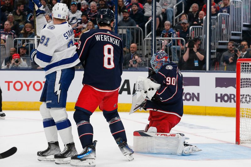 Feb 10, 2024; Columbus, Ohio, USA; Columbus Blue Jackets goalie Elvis Merzlikins (90) takes a puck off his mask during the first period against the Tampa Bay Lightning at Nationwide Arena. Mandatory Credit: Russell LaBounty-USA TODAY Sports