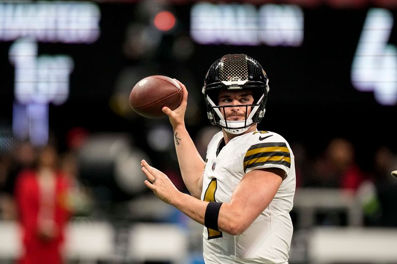 New Orleans Saints quarterback Derek Carr (4) warms up before an NFL football game against the Atlanta Falcons, Sunday, Nov. 26, 2023, in Atlanta. (AP Photo/Brynn Anderson)