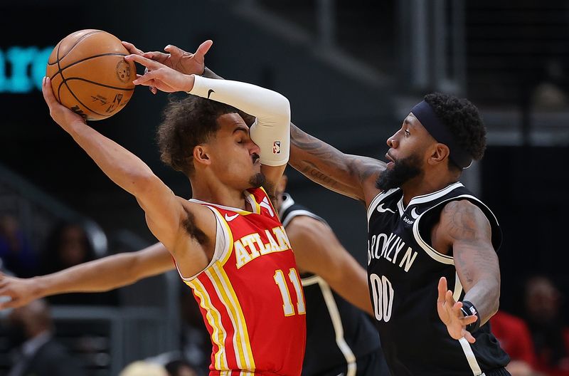 ATLANTA, GEORGIA - DECEMBER 06:  Royce O'Neale #00 of the Brooklyn Nets defends against Trae Young #11 of the Atlanta Hawks during the third quarter at State Farm Arena on December 06, 2023 in Atlanta, Georgia.  NOTE TO USER: User expressly acknowledges and agrees that, by downloading and/or using this photograph, user is consenting to the terms and conditions of the Getty Images License Agreement.  (Photo by Kevin C. Cox/Getty Images)