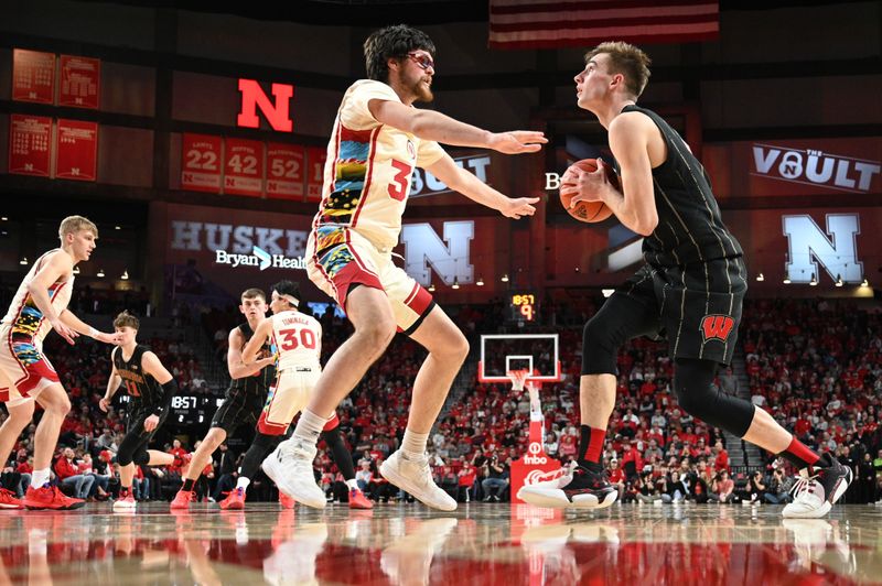 Feb 11, 2023; Lincoln, Nebraska, USA;  Wisconsin Badgers forward Tyler Wahl (5) drives against Nebraska Cornhuskers forward Wilhelm Breidenbach (32) in the second half at Pinnacle Bank Arena. Mandatory Credit: Steven Branscombe-USA TODAY Sports