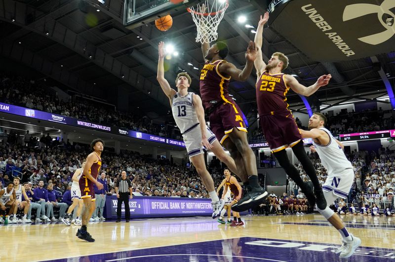 Mar 9, 2024; Evanston, Illinois, USA; Minnesota Golden Gophers forward Pharrel Payne (21) defends Northwestern Wildcats guard Brooks Barnhizer (13) during the second half at Welsh-Ryan Arena. Mandatory Credit: David Banks-USA TODAY Sports