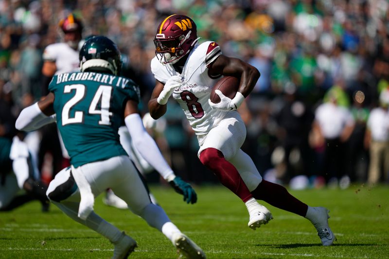 Washington Commanders running back Brian Robinson Jr. (8) runs with the ball under pressure from Philadelphia Eagles cornerback James Bradberry (24) during the first half of an NFL football game Sunday, Oct. 1, 2023, in Philadelphia. (AP Photo/Matt Rourke)