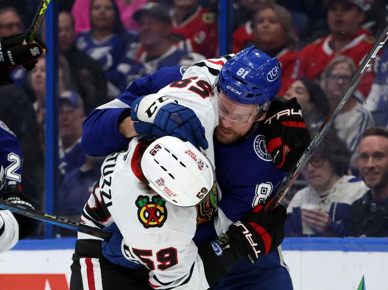 Jan 28, 2025; Tampa, Florida, USA; Chicago Blackhawks left wing Tyler Bertuzzi (59) and Tampa Bay Lightning defenseman Erik Cernak (81) fight during the second period at Amalie Arena. Mandatory Credit: Kim Klement Neitzel-Imagn Images