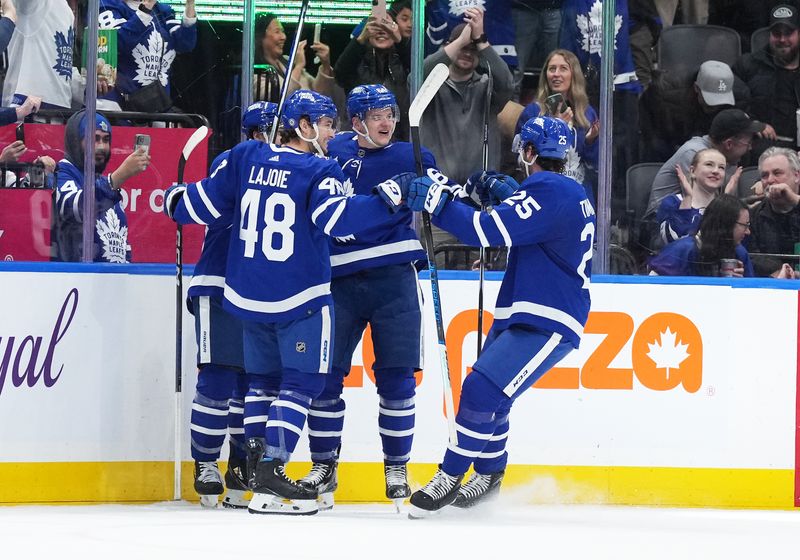 Dec 9, 2023; Toronto, Ontario, CAN; Toronto Maple Leafs center David Kampf (64) scores a goal and celebrates with Toronto Maple Leafs defenseman Conor Timmins (25) against the Nashville Predators during the second period at Scotiabank Arena. Mandatory Credit: Nick Turchiaro-USA TODAY Sports