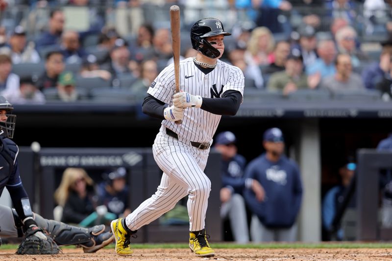 Apr 21, 2024; Bronx, New York, USA; New York Yankees left fielder Alex Verdugo (24) follows through on a two run single against the Tampa Bay Rays during the fifth inning at Yankee Stadium. Mandatory Credit: Brad Penner-USA TODAY Sports