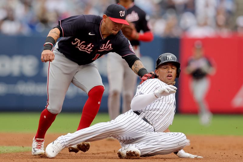 Aug 24, 2023; Bronx, New York, USA; New York Yankees third baseman Oswald Peraza (91) is tagged out by Washington Nationals second baseman Ildemaro Vargas (14) in a rundown after being picked off first base during the second inning at Yankee Stadium. Mandatory Credit: Brad Penner-USA TODAY Sports