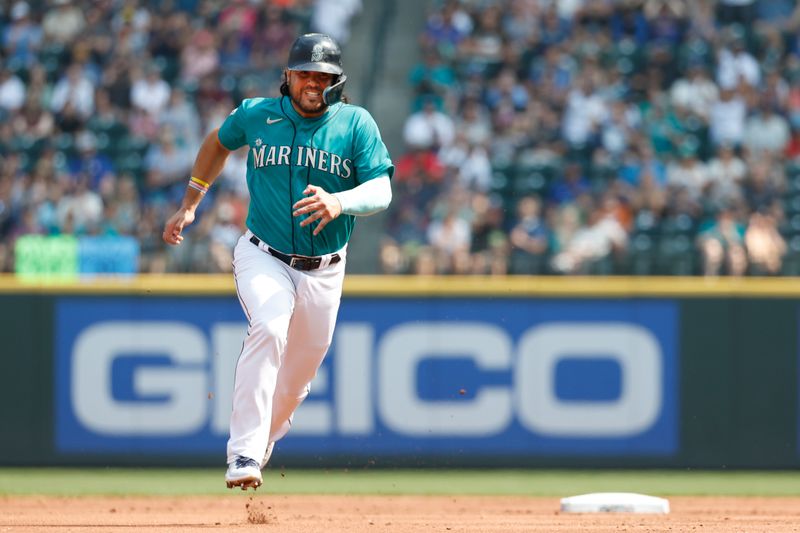 Aug 28, 2023; Seattle, Washington, USA; Seattle Mariners third baseman Eugenio Suarez (28) advances to third base on an error by the Kansas City Royals during the first inning at T-Mobile Park. Mandatory Credit: Joe Nicholson-USA TODAY Sports