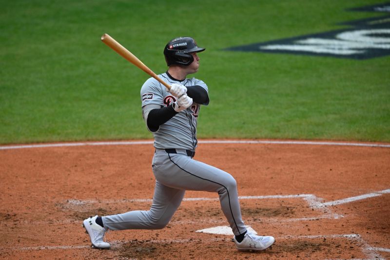 Oct 12, 2024; Cleveland, Ohio, USA; Detroit Tigers outfielder Kerry Carpenter (30) hits a single in the fifth inning against the Cleveland Guardians during game five of the ALDS for the 2024 MLB Playoffs at Progressive Field. Mandatory Credit: David Richard-Imagn Images