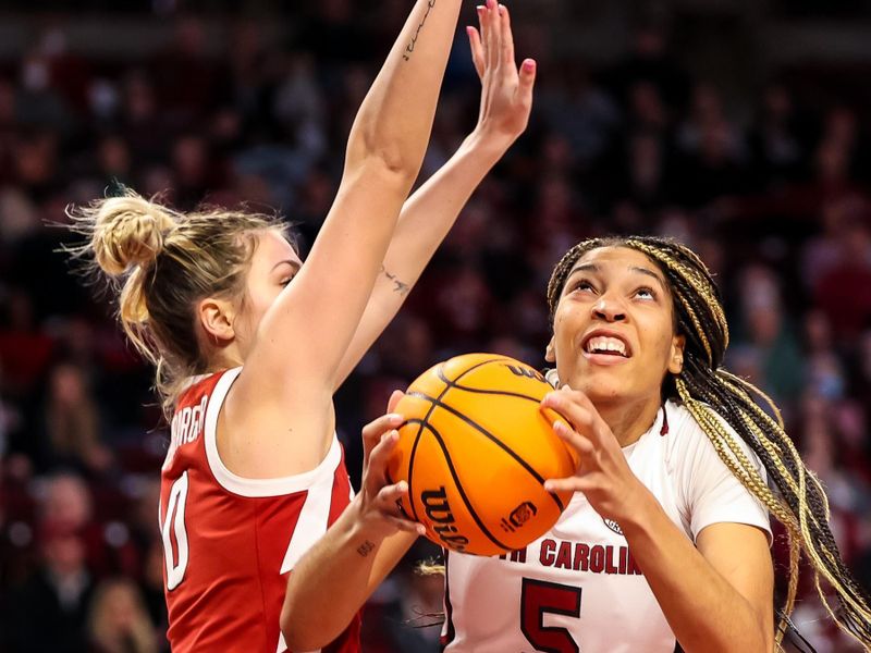 Jan 22, 2023; Columbia, South Carolina, USA; South Carolina Gamecocks forward Victaria Saxton (5) drives around Arkansas Razorbacks guard Saylor Poffenbarger (0) in the first half at Colonial Life Arena. Mandatory Credit: Jeff Blake-USA TODAY Sports