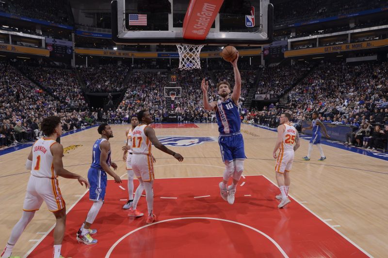 SACRAMENTO, CA - JANUARY 22: Domantas Sabonis #10 of the Sacramento Kings drives to the basket during the game against the Atlanta Hawks on January 22, 2024 at Golden 1 Center in Sacramento, California. NOTE TO USER: User expressly acknowledges and agrees that, by downloading and or using this Photograph, user is consenting to the terms and conditions of the Getty Images License Agreement. Mandatory Copyright Notice: Copyright 2024 NBAE (Photo by Rocky Widner/NBAE via Getty Images)