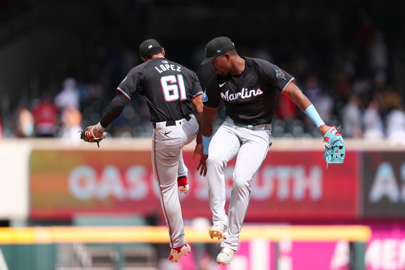 Aug 4, 2024; Cumberland, Georgia, USA; Miami Marlins second baseman Otto Lopez (61) and right fielder Jesus Sanchez (12) celebrate after a win against the Atlanta Braves at Truist Park. Mandatory Credit: Mady Mertens-USA TODAY Sports