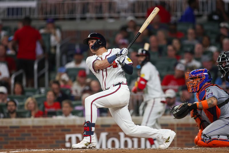 Sep 24, 2024; Atlanta, Georgia, USA; Atlanta Braves third baseman Gio Urshela (9) hits a double against the New York Mets in the sixth inning at Truist Park. Mandatory Credit: Brett Davis-Imagn Images