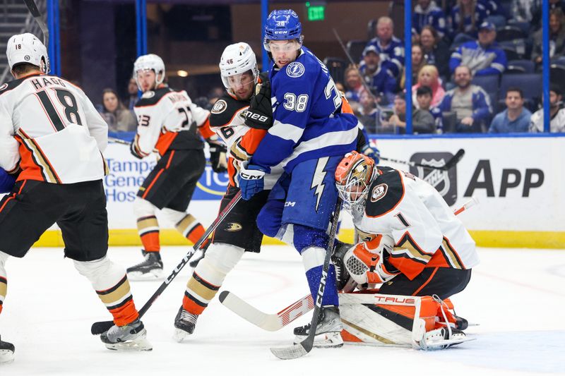 Jan 13, 2024; Tampa, Florida, USA;  Anaheim Ducks goaltender Lukas Dostal (1) makes a save behind Tampa Bay Lightning left wing Brandon Hagel (38) in the first period  at Amalie Arena. Mandatory Credit: Nathan Ray Seebeck-USA TODAY Sports