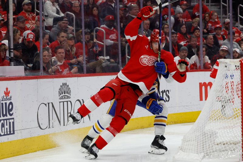 Apr 7, 2024; Detroit, Michigan, USA; Detroit Red Wings defenseman Simon Edvinsson (77) and Buffalo Sabres left wing Jordan Greenway (12) fight for position in the third period at Little Caesars Arena. Mandatory Credit: Rick Osentoski-USA TODAY Sports