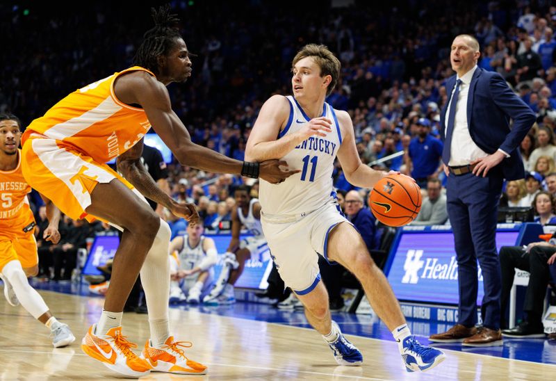 Feb 11, 2025; Lexington, Kentucky, USA; Kentucky Wildcats guard Travis Perry (11) drives to the basket against Tennessee Volunteers forward Felix Okpara (34) during the second half at Rupp Arena at Central Bank Center. Mandatory Credit: Jordan Prather-Imagn Images