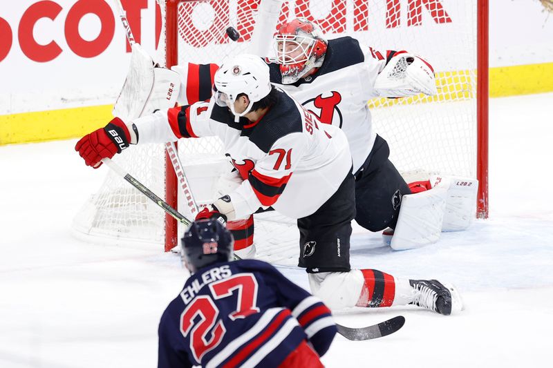 Apr 2, 2023; Winnipeg, Manitoba, CAN; Winnipeg Jets left wing Nikolaj Ehlers (27) scores on New Jersey Devils goaltender Vitek Vanecek (41) in the third period at Canada Life Centre. Mandatory Credit: James Carey Lauder-USA TODAY Sports