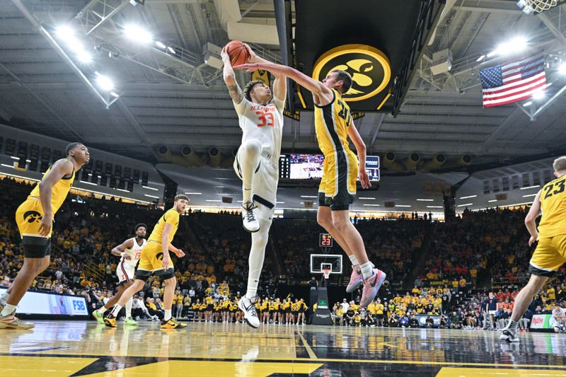 Mar 10, 2024; Iowa City, Iowa, USA; Illinois Fighting Illini forward Coleman Hawkins (33) goes to the basket as Iowa Hawkeyes forward Payton Sandfort (20) defends and guard Tony Perkins (11) and forward Owen Freeman (32) look on during the first half at Carver-Hawkeye Arena. Mandatory Credit: Jeffrey Becker-USA TODAY Sports