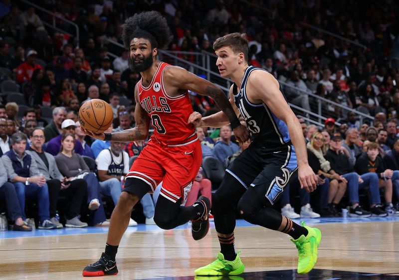 ATLANTA, GEORGIA - FEBRUARY 12:  Coby White #0 of the Chicago Bulls drives against Bogdan Bogdanovic #13 of the Atlanta Hawks during the third quarter at State Farm Arena on February 12, 2024 in Atlanta, Georgia.  NOTE TO USER: User expressly acknowledges and agrees that, by downloading and/or using this photograph, user is consenting to the terms and conditions of the Getty Images License Agreement.  (Photo by Kevin C. Cox/Getty Images)