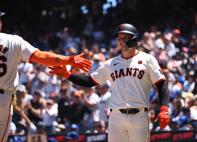 Jun 30, 2024; San Francisco, California, USA; San Francisco Giants catcher Patrick Bailey (14) waits to high five third baseman Matt Chapman (26) after Chapman batted him in on a two-run home run against the Los Angeles Dodgers during the fourth inning at Oracle Park. Mandatory Credit: Kelley L Cox-USA TODAY Sports