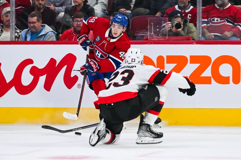 Oct 12, 2024; Montreal, Quebec, CAN; Montreal Canadiens defenseman Lane Hutson (48) plays the puck against Ottawa Senators defenseman Travis Hamonic (23) during the first period at Bell Centre. Mandatory Credit: David Kirouac-Imagn Images