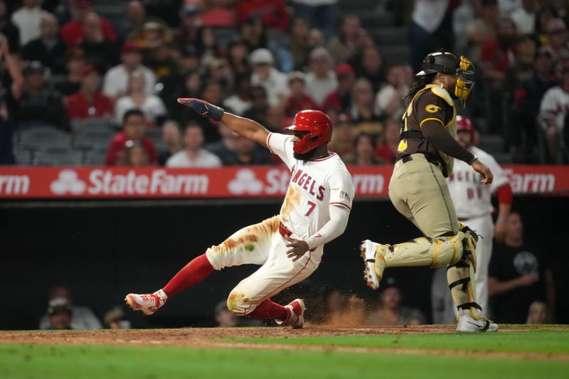 Jun 3, 2024; Anaheim, California, USA; Los Angeles Angels right fielder Jo Adell (7) slides into home plate to score in the eight inning against the San Diego Padres at Angel Stadium. Mandatory Credit: Kirby Lee-USA TODAY Sports