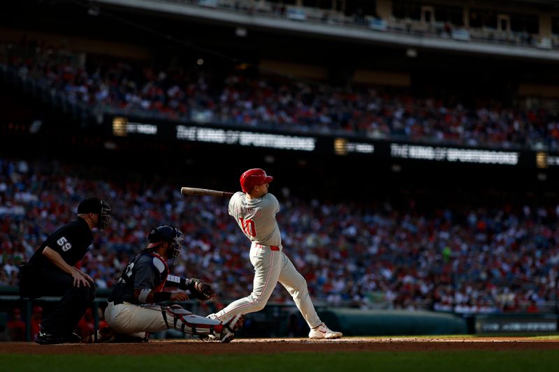 Sep 28, 2024; Washington, District of Columbia, USA;  Philadelphia Phillies catcher J.T. Realmuto (10) singles against the Washington Nationals during the second inning at Nationals Park. Mandatory Credit: Geoff Burke-Imagn Images