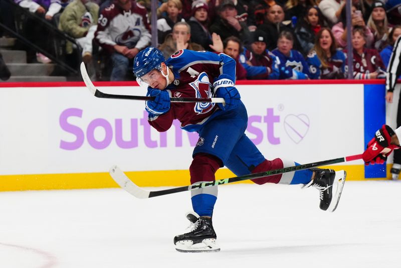 Nov 9, 2024; Denver, Colorado, USA; Colorado Avalanche defenseman Cale Makar (8) shoots and scores a goal in the second period against the Carolina Hurricanes at Ball Arena. Mandatory Credit: Ron Chenoy-Imagn Images