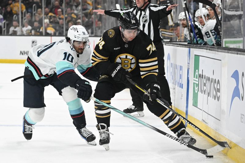 Feb 15, 2024; Boston, Massachusetts, USA; Boston Bruins left-wing Jake DeBrusk (74) and Seattle Kraken center Matty Beniers (10) battle for the puck during the third period at the TD Garden. Mandatory Credit: Brian Fluharty-USA TODAY Sports