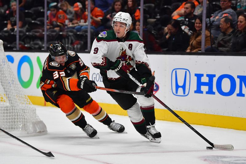 Oct 5, 2023; Anaheim, California, USA; Arizona Coyotes right wing Clayton Keller (9) moves the puck ahead of Anaheim Ducks right wing Jakob Silfverberg (33) during the first period at Honda Center. Mandatory Credit: Gary A. Vasquez-USA TODAY Sports