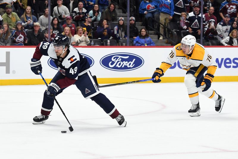 Nov 11, 2024; Denver, Colorado, USA; Colorado Avalanche defenseman Samuel Girard (49) scores the game-winning goal in overtime after taking the puck from Nashville Predators defenseman Brady Skjei (76) at Ball Arena. Mandatory Credit: Christopher Hanewinckel-Imagn Images